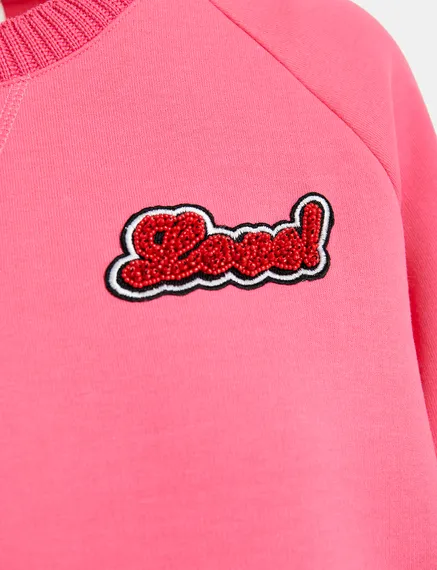 Pink sweatshirt with bead embellishment