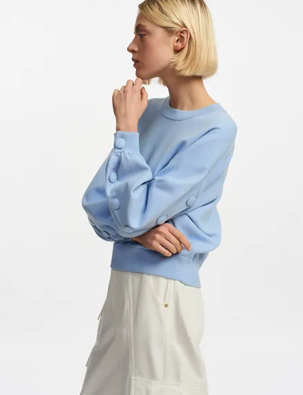 Light blue knitted sweater with buttoned sleeves