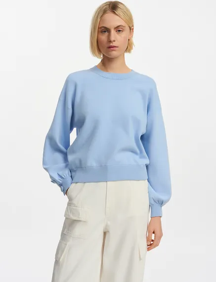 Light blue knitted sweater with buttoned sleeves