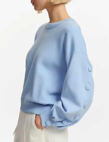 Light blue knitted sweater with buttoned sleeves