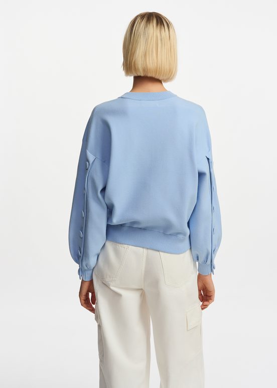 Light blue knitted sweater with buttoned sleeves