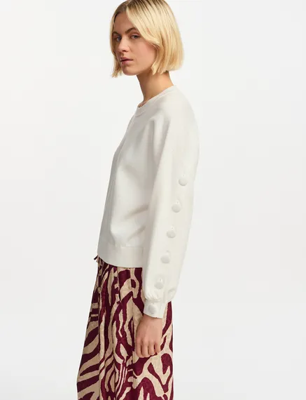 Off-white knitted sweater with buttoned sleeves