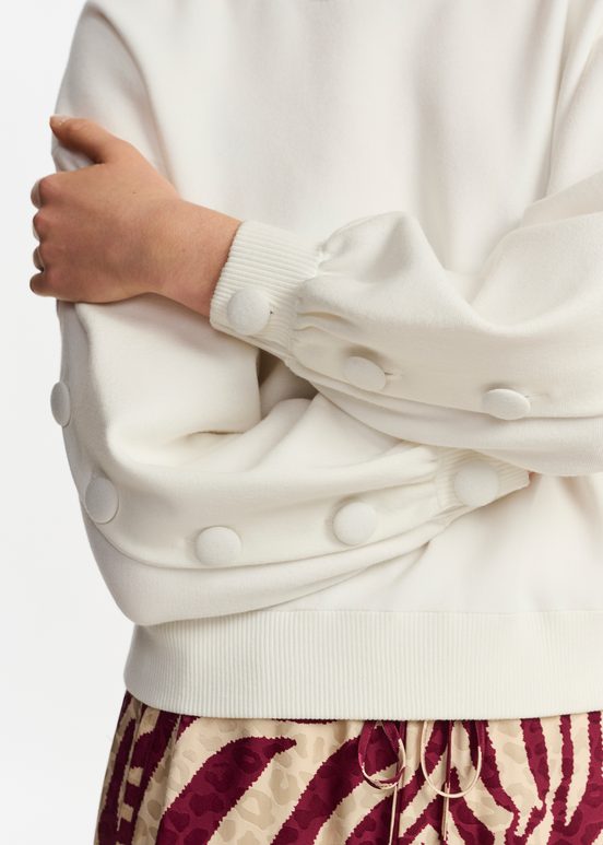 Off-white knitted sweater with buttoned sleeves