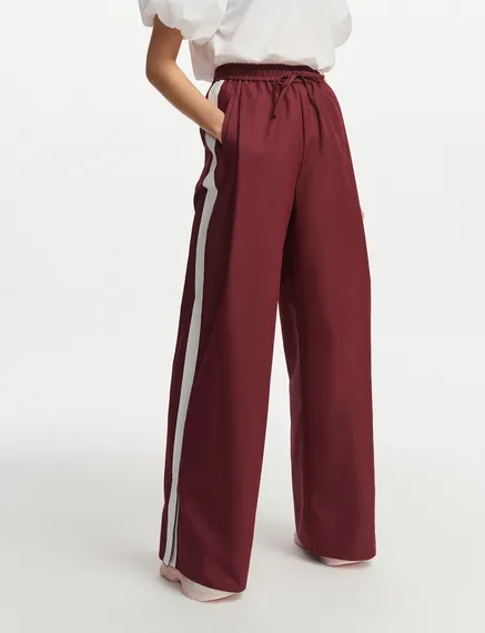 Burgundy wide-leg pants with white stripes