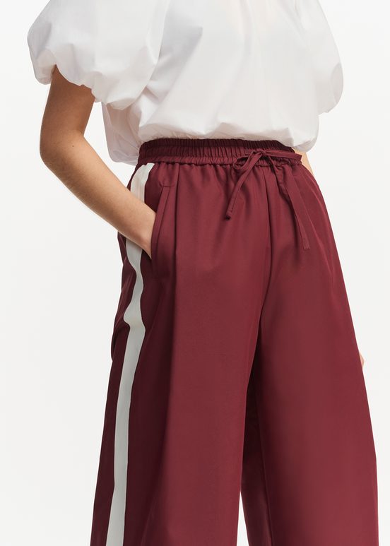 Burgundy wide-leg pants with white stripes