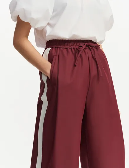 Burgundy wide-leg pants with white stripes