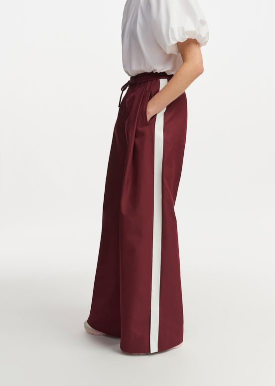 Burgundy wide-leg pants with white stripes