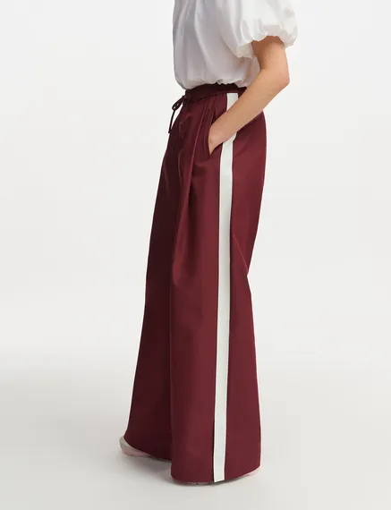 Burgundy wide-leg pants with white stripes