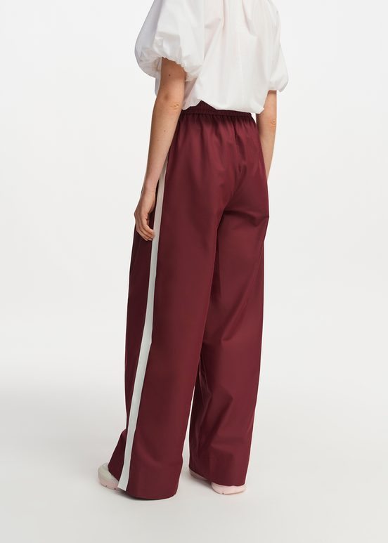 Burgundy wide-leg pants with white stripes