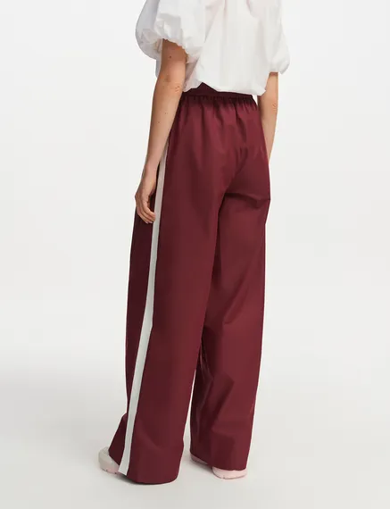 Burgundy wide-leg pants with white stripes