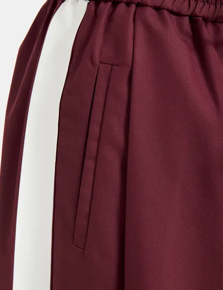 Burgundy wide-leg pants with white stripes