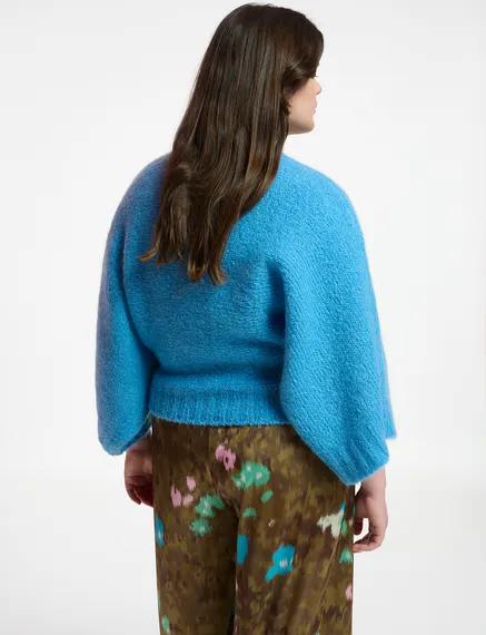 Blue knit sweater with cape effect