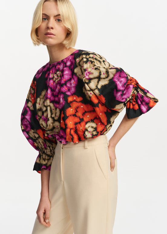 Black, orange and ecru top with puffed sleeves