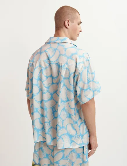 Blue and off-white short-sleeved shirt with abstract print