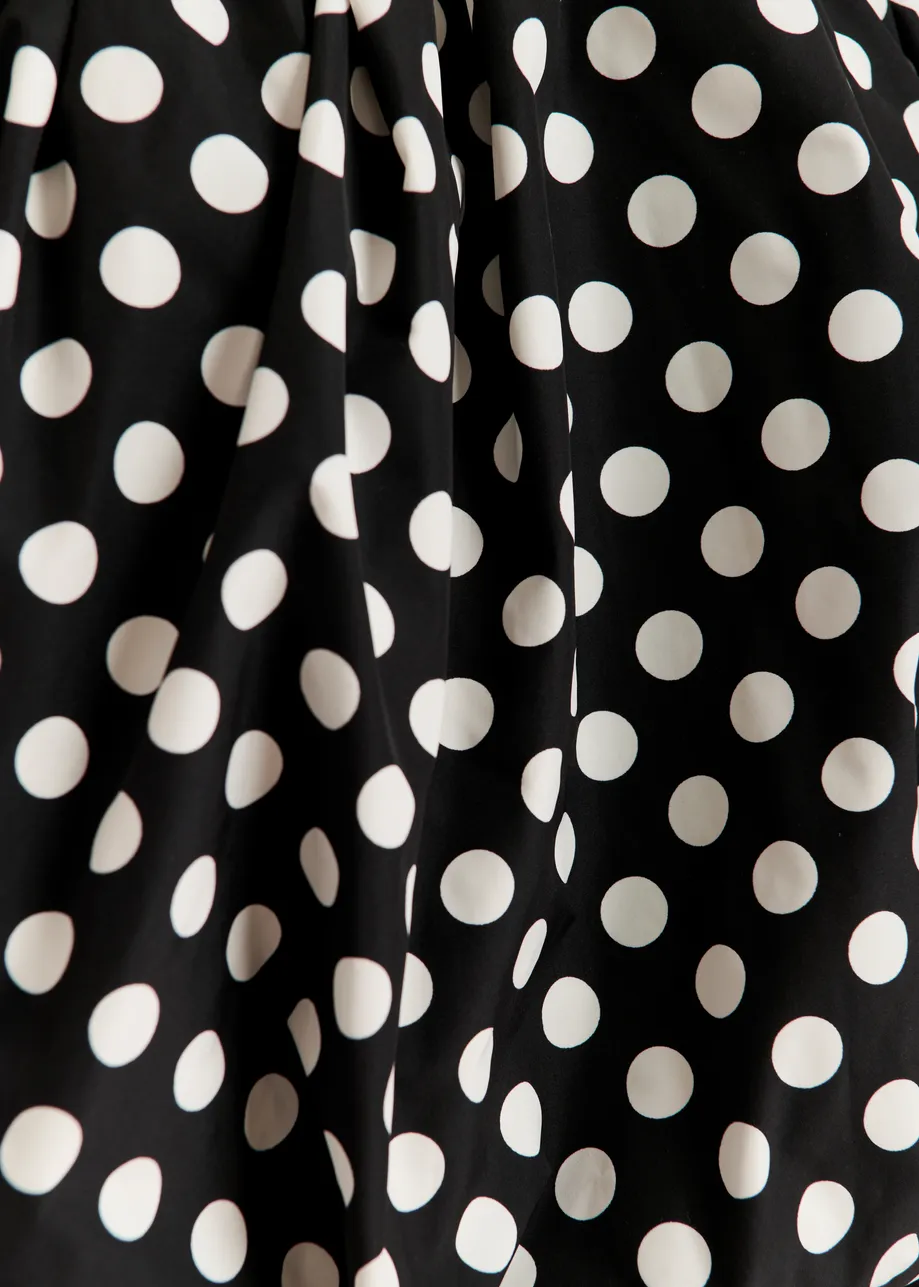 Black and white polka-dot gathered bodysuit with puffed sleeves