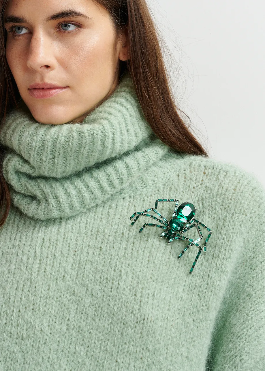 Broche araña con pedrería en verde oscuro