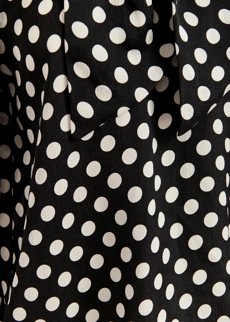 Black and white polka-dot top with pussy bow