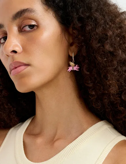 Gold-tone hoop earrings with champagne bottle and flying pig pendants