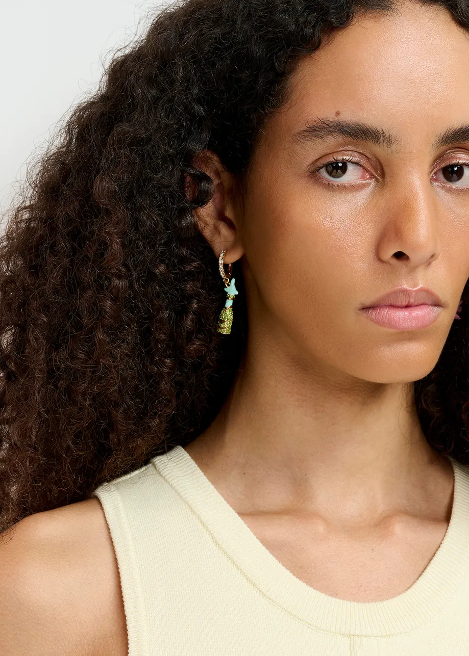 Gold-tone hoop earrings with champagne bottle and flying pig pendants