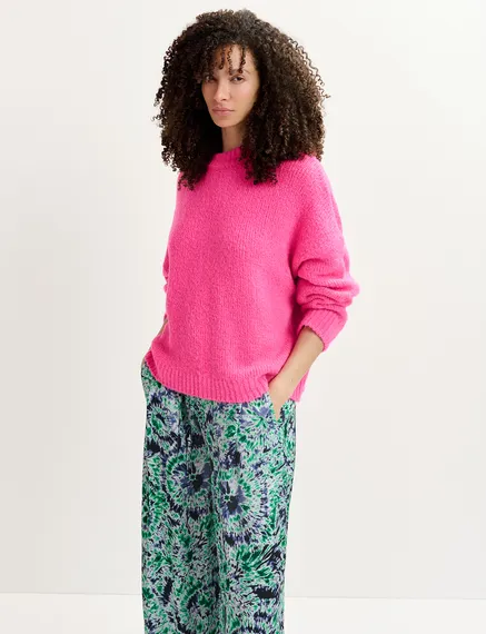 Pull en gros tricot rose fluo