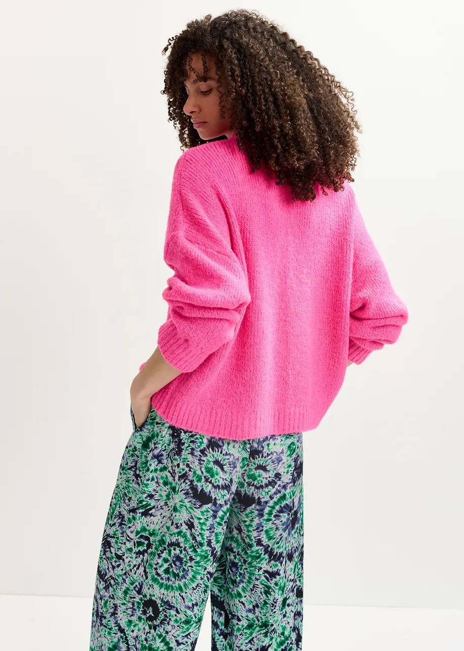 Pull en gros tricot rose fluo