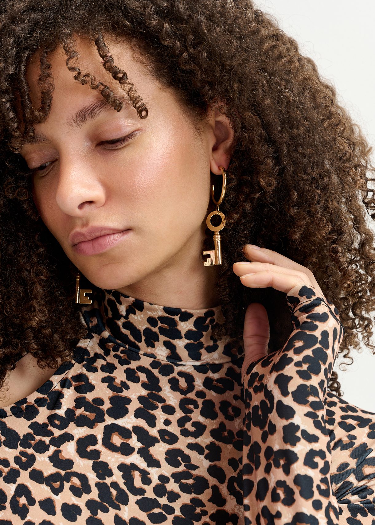 Gold-tone hoop earrings with key pendants