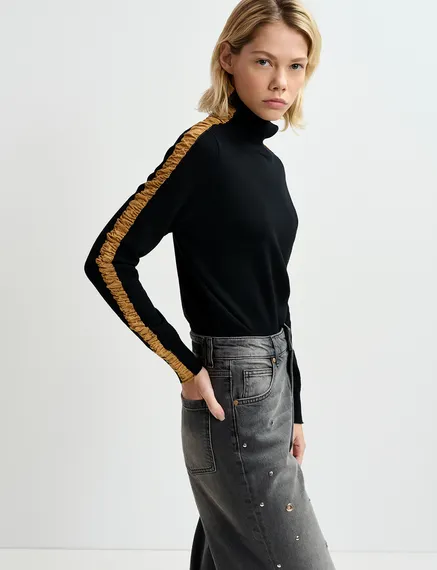 Black turtleneck knit sweater with golden stripes