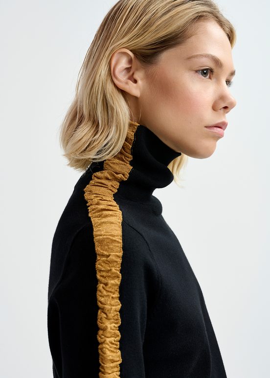 Black turtleneck knit sweater with golden stripes