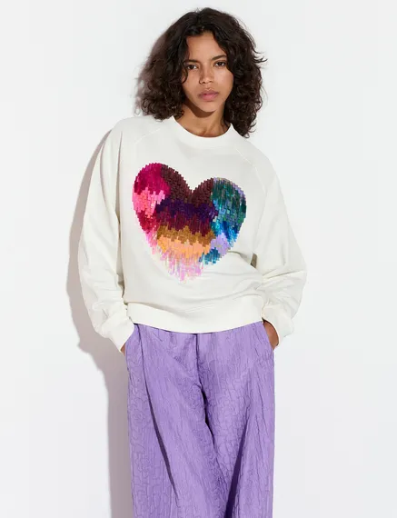 Gebroken witte biokatoenen sweater met hart van pailletten