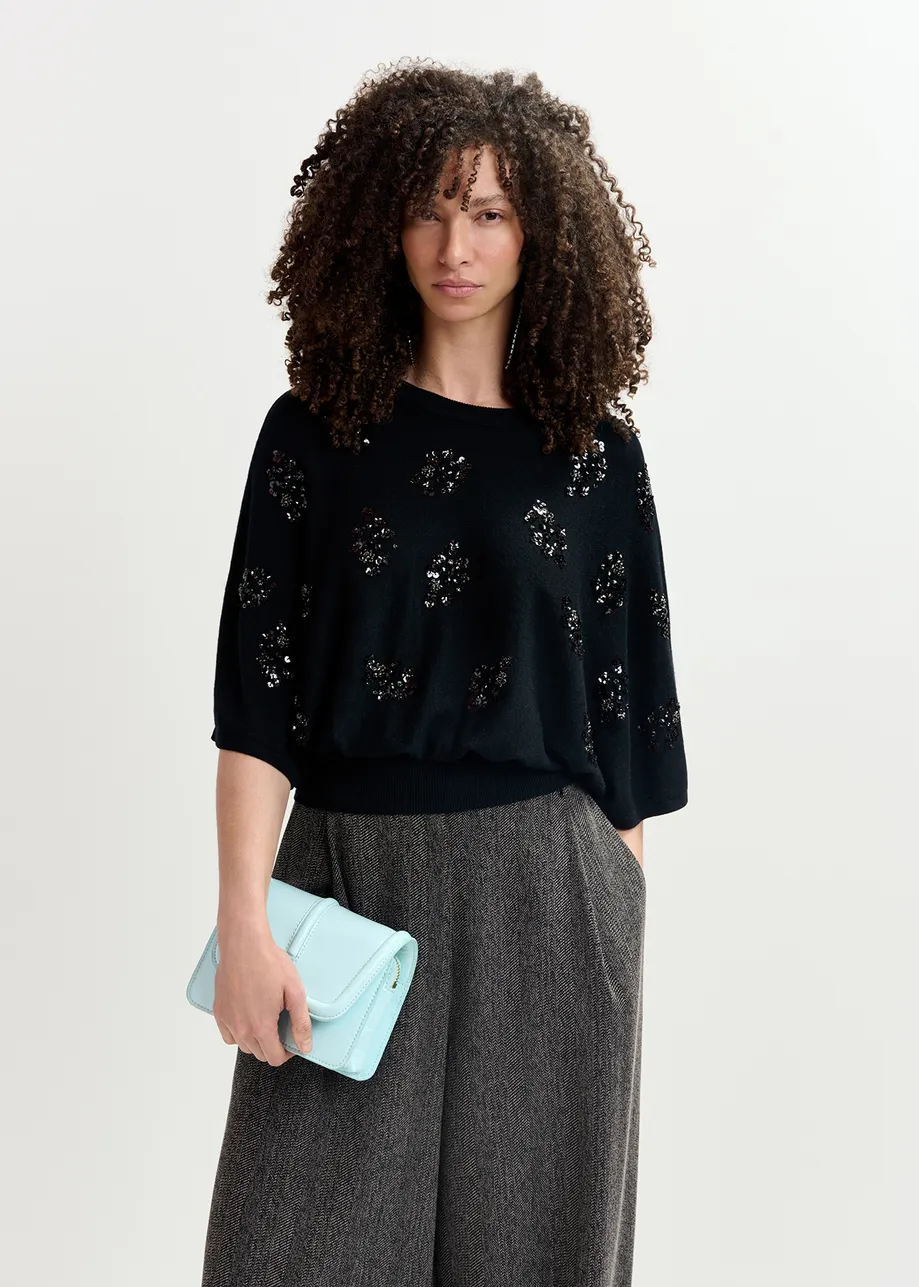 Black cape-effect knit sweater with embellishments