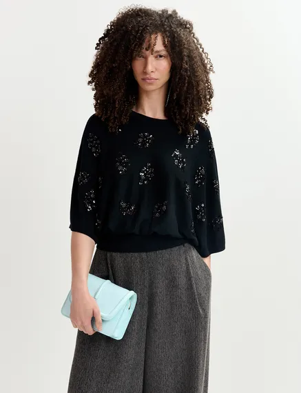 Black cape-effect knit sweater with embellishments