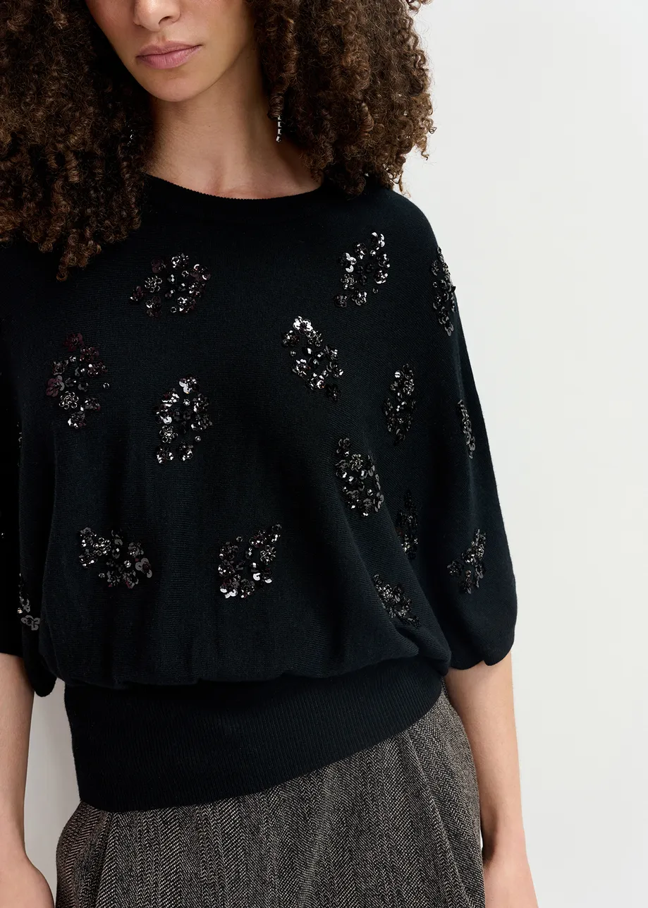 Black cape-effect knit sweater with embellishments