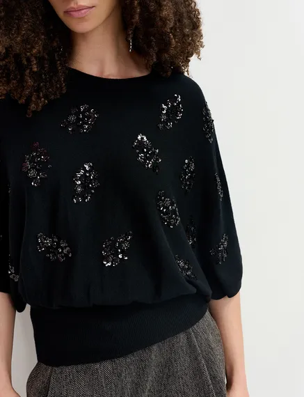 Black cape-effect knit sweater with embellishments