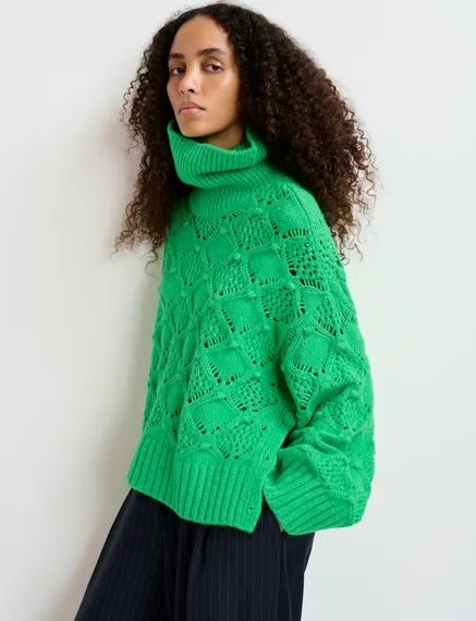 Green cable-knit turtleneck sweater