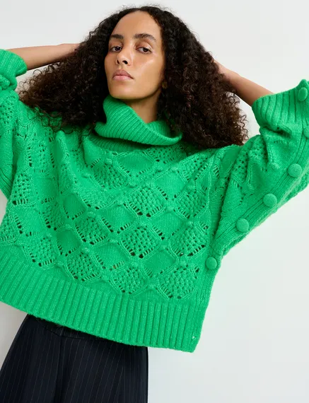 Green cable-knit turtleneck sweater