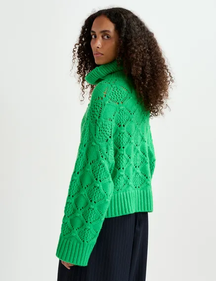 Green cable-knit turtleneck sweater