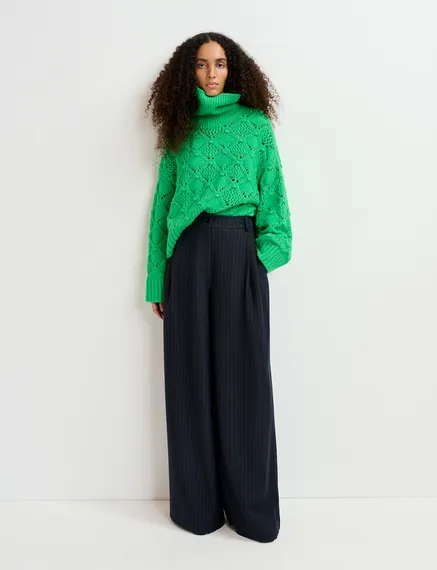 Green cable-knit turtleneck sweater