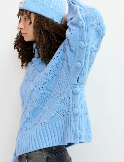 Blue cable-knit turtleneck sweater