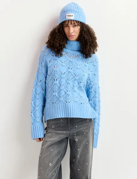 Blue cable-knit turtleneck sweater