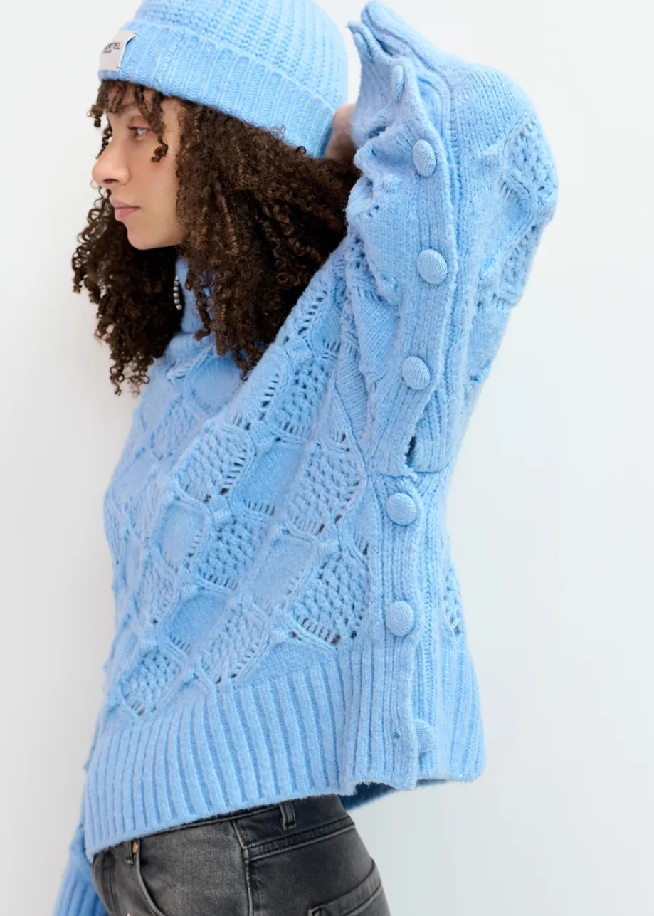 Blue cable-knit turtleneck sweater