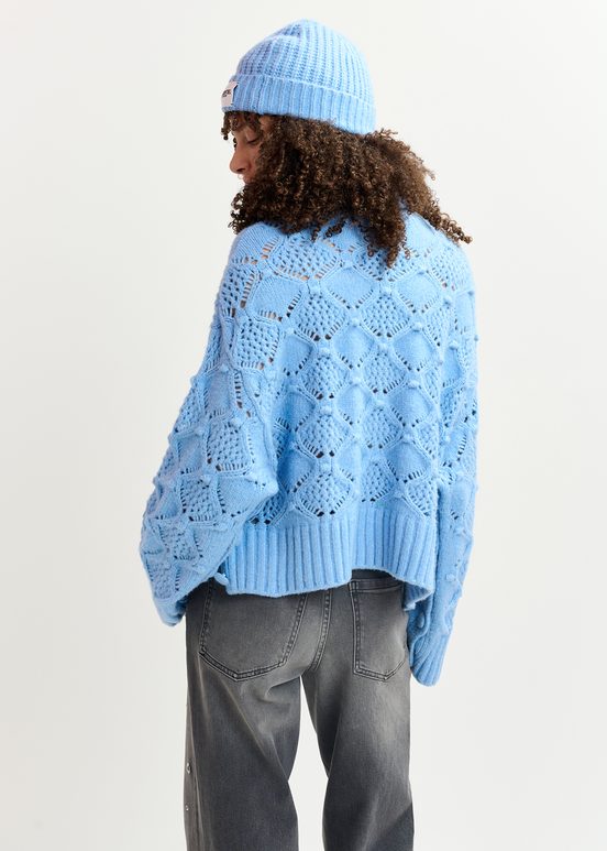 Blue cable-knit turtleneck sweater