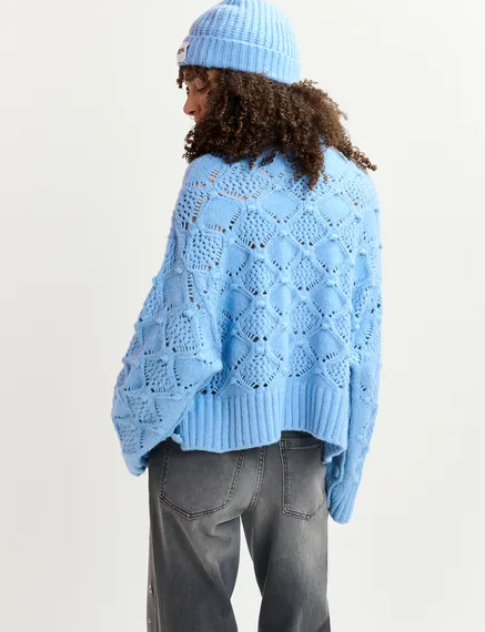 Blue cable-knit turtleneck sweater