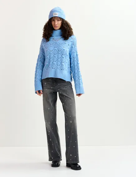 Blue cable-knit turtleneck sweater