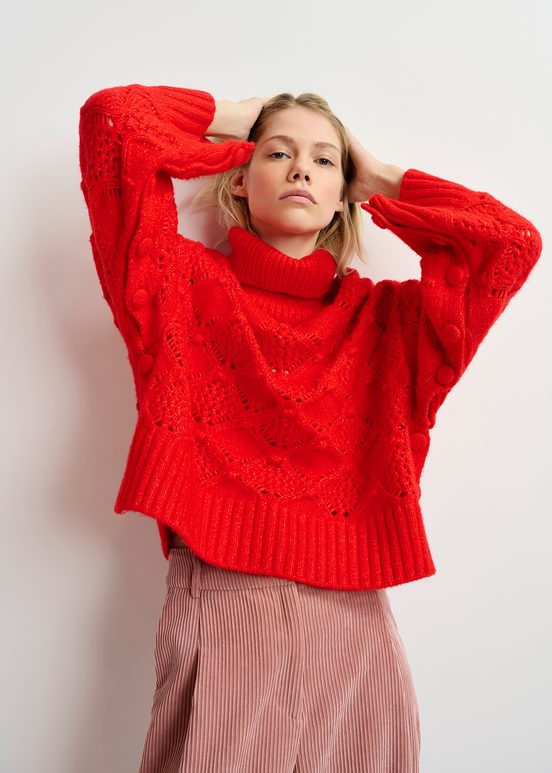 Red cable-knit turtleneck sweater