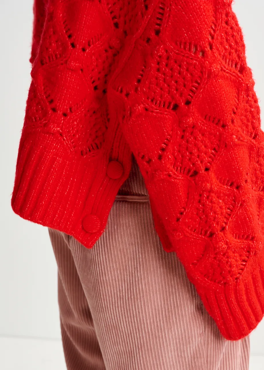 Red cable-knit turtleneck sweater