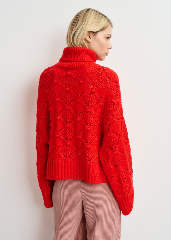 Red cable-knit turtleneck sweater