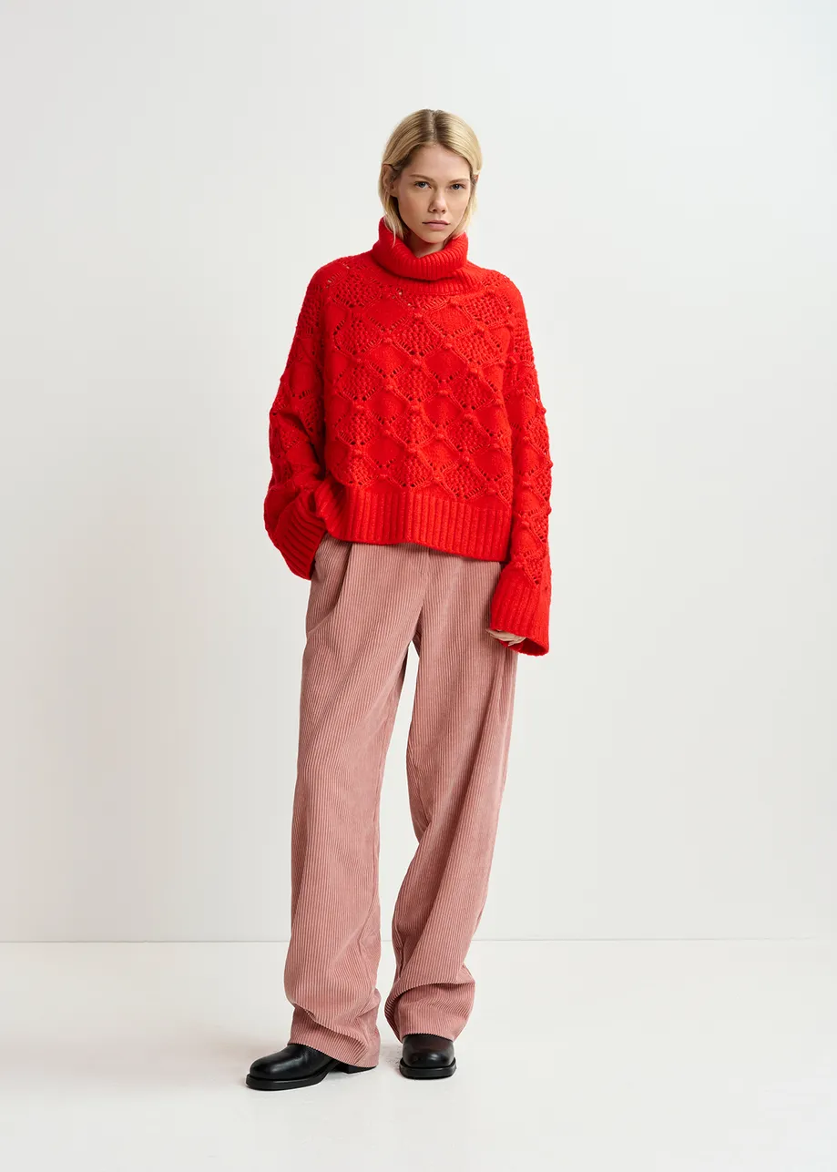 Red cable-knit turtleneck sweater