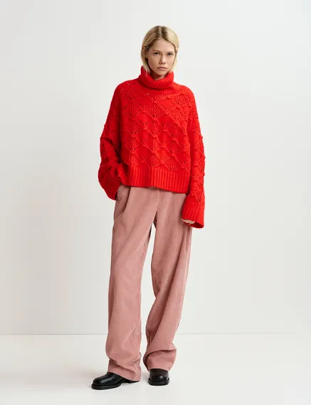 Red cable-knit turtleneck sweater