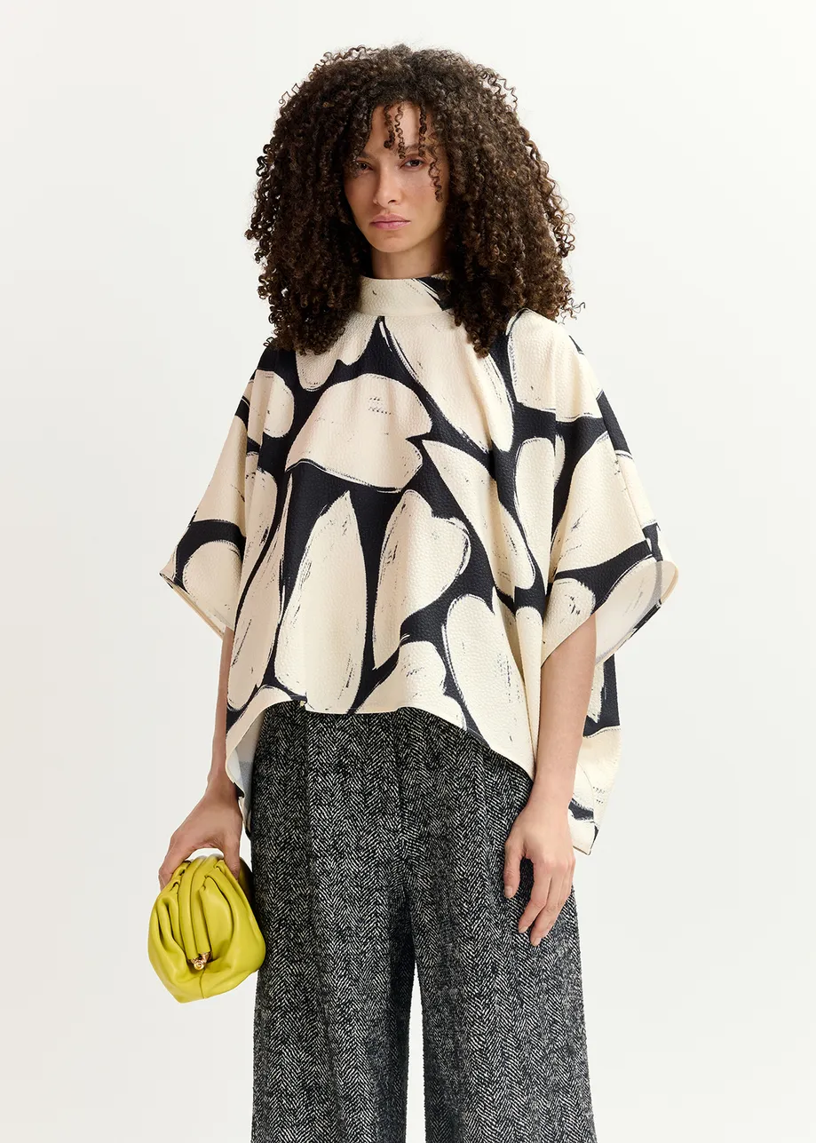 Black and off-white oversized top with stand-up collar