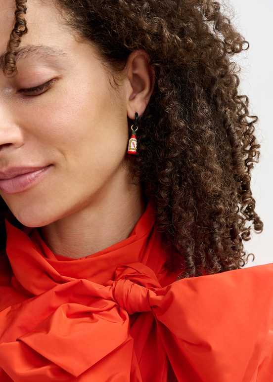 Black hoop earrings with crocodile and hot sauce pendants